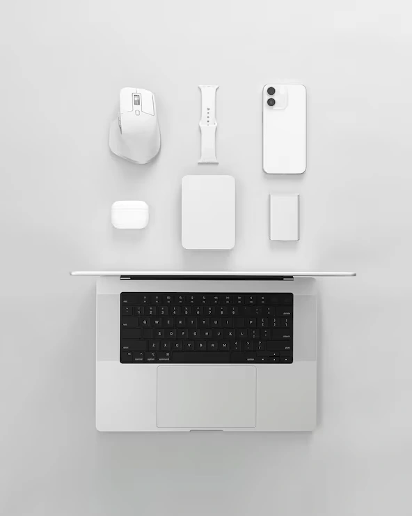 Laptop and white accessories arranged on a light desktop